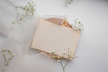 card mockup with white flowers and envelope. wedding invitation 