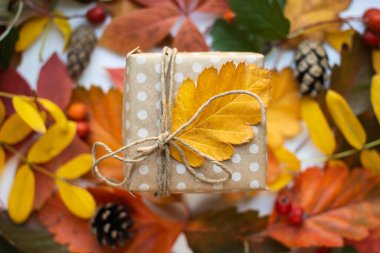modern gift wrapping. doted craft gift. present box with copy place and autumn leaves