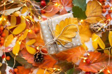 modern gift wrapping. doted craft gift. present box with copy place and autumn leaves
