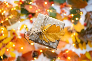 modern gift wrapping. doted craft gift. present box with copy place and autumn leaves