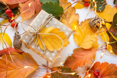 modern gift wrapping. doted craft gift. present box with copy place and autumn leaves