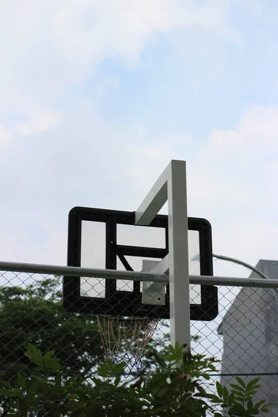 back view of basketball hoop. with a clear sky background