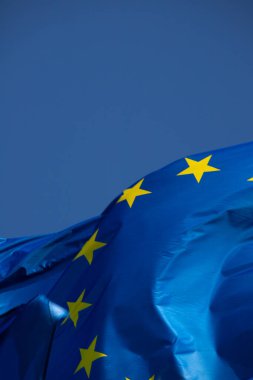 European flag in the wind with a beautiful blue sky in the background. Place to place text