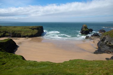 beautiful view of the beach from the Ballybunion cliffs in Ireland. blue sky and sun.