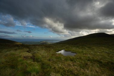 beautiful view of an Ireland landscape. Set of lakes with beautiful light and a ray of sunshine shining through the clouds