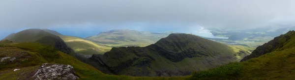 spectacular panoramic view of an Irish landscape in Kerry. Shade and sun with a bit of fog over the hills