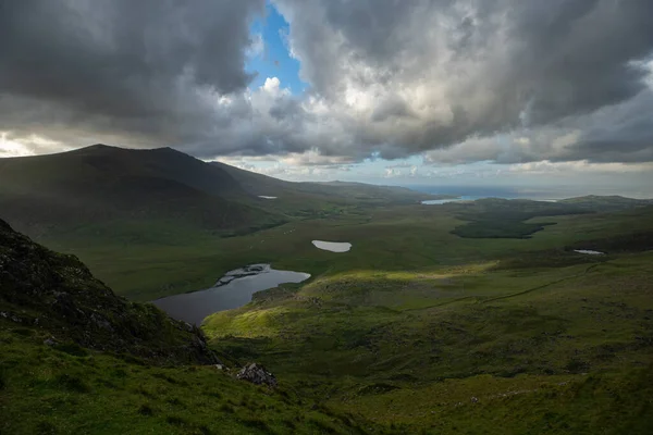 beautiful view of an Ireland landscape. Set of lakes with beautiful light and a ray of sunshine shining through the clouds