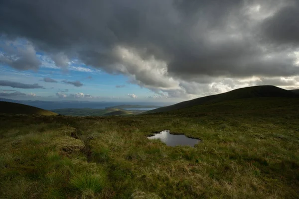 beautiful view of an Ireland landscape. Set of lakes with beautiful light and a ray of sunshine shining through the clouds