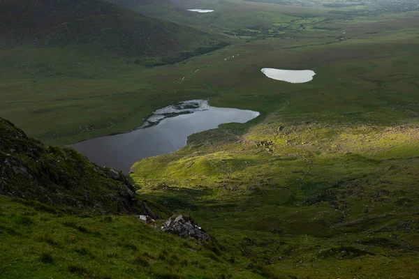beautiful view of an Ireland landscape. Set of lakes with beautiful light and a ray of sunshine shining through the clouds