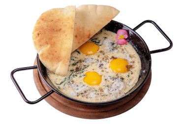 Omelet with parmesan, georgian bread, parsley and violet in a plate on a white background