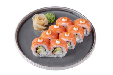 Roll with philadelphia cheese, salmon, salmon caviar, avocado, cucumber, rice, nori, wasabi and ginger in a dish on a white plate