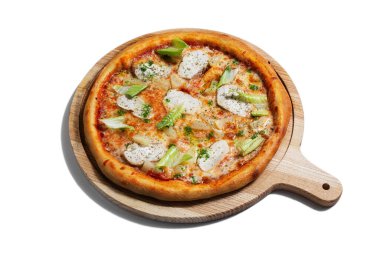 Pizza with cheese, chicken, salad, pineapple and sauce on a wooden board on a white plate