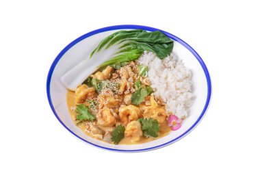 Shrimps with mushrooms, peanuts, sesame seeds, rice, violets, parsley, salad and sauce in a plate on a white plate