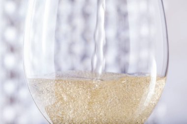 Champagne in a glass on a background of shiny toys
