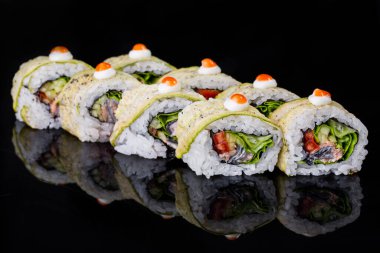 Roll with eel, pepper, zucchini, cucumber, salad, nori rice and cream cheese on a black mirror background
