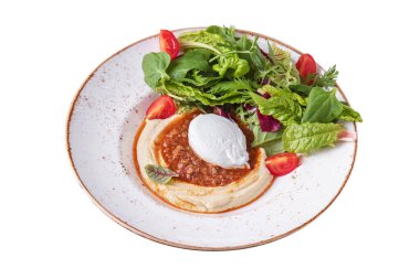 Puree with pieces of meat, mozzarella, tomatoes, arugula, basil, salad, endive in a plate on a white plate