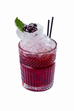 Cocktail with ice, basil, cranberries and straws in a glass on a white background