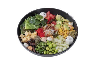 Salad with eel, beans, cucumber, avocado, corn, rice, tobiko caviar, mushrooms, chukoy, peppers, tomatoes, mozzarella, spinach, nori and sesame seeds in a plate on a white background