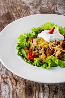 Peynirli salata, ekşi krema, et, patates, zeytin ve salata.