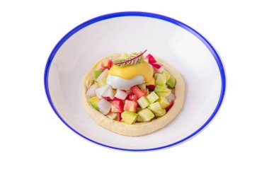 Puree with avocado, mozzarella, radish, tomatoes, cucumber, basil and white sauce in a plate on a white plate