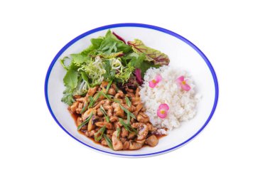 Fish meat, mushrooms, onions, rice, parsley, endive, salad, basil and violets in a plate on a white background