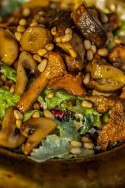 Salad with mushrooms, seeds, champignons on a plate on the table