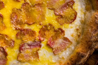 Pizza with cheese and bacon in a plate on the table