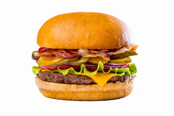 Burger with lettuce, meat cutlet, tomatoes, fried bacon, pickled cucumbers and cheese on a white background. Horizontal orientation