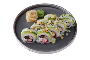 Rolls with shrimps, rice, sauce, sesame seeds, avocado, nori, Philadelphia cheese with wasabi, ginger on a platter on a white plate