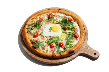 Pizza with egg, arugula, cheese, tomatoes, bacon and sauce on a wooden board on a white background