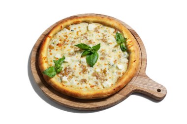 Pizza with different types of cheese, cheddar, mozzarella, dor blue, parmesan and basil on a wooden board on a white background