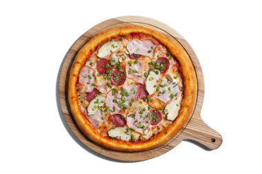 Pizza with cheese, ham, chicken, onion, sausages and sauce on a wooden board on a white background