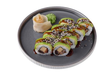 Rolls with shrimps, rice, sauce, sesame seeds, avocado, nori, Philadelphia cheese with wasabi, ginger on a platter on a white plate