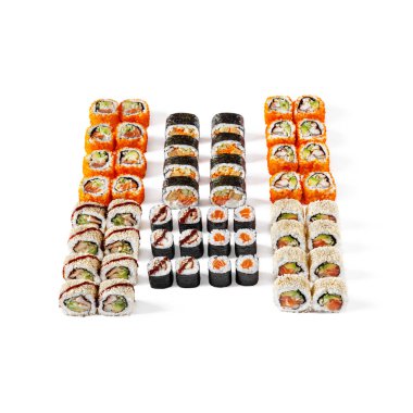 Assorted different rolls, with salmon, shrimps, sesame seeds, eel, avocado, tobiko caviar, cucumbers, omelet, on a white background