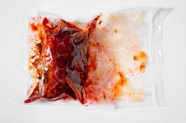 Vacuum packed raw marinated meat on white background