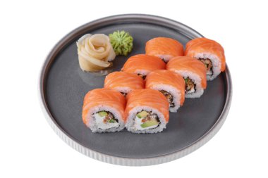 Roll with philadelphia cheese, salmon, eel, avocado, rice, nori, wasabi and ginger in a dish on a white plate