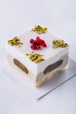 Milk dessert ice cream with different layers, and chopped peanuts and beak on a light background. Vertical orientation