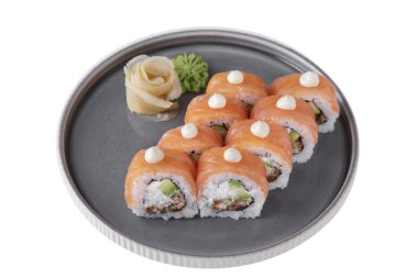 Roll with philadelphia cheese, salmon, eel, avocado, rice, nori, wasabi and ginger in a dish on a white plate