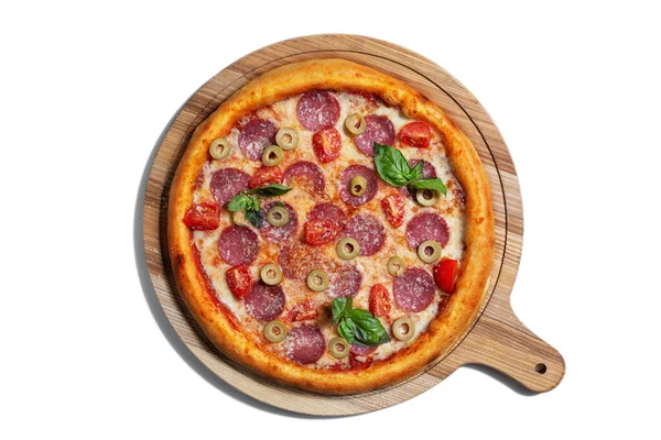 Pizza with cheese, olives, pepperoni, tomatoes, basil and sauce on a wooden board on a white background