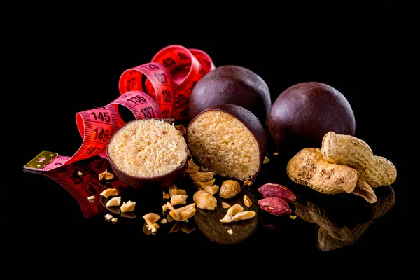 Sweet Balls Covered Chocolate Icing Peanuts Centimeter Tape Black Background — Foto Stock