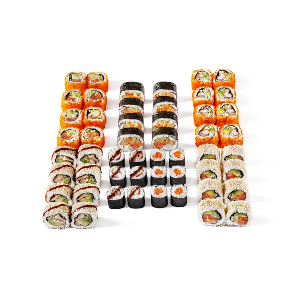 Assorted different rolls, with salmon, shrimps, sesame seeds, eel, avocado, tobiko caviar, cucumbers, omelet, on a white background