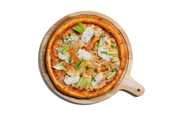 Pizza with cheese, chicken, salad, pineapple and sauce on a wooden board on a white plate
