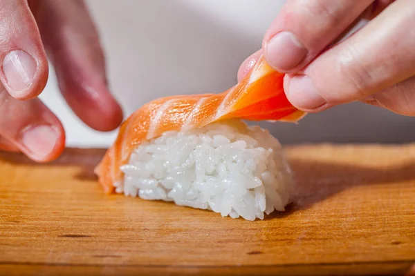 Male Hands Laying Salmon Fillets Sushi Sushi Wooden Board — ストック写真