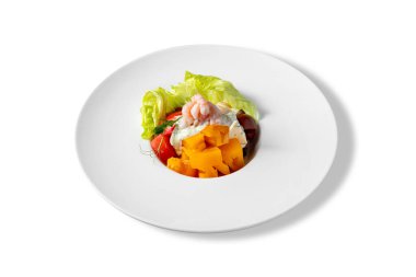 Salad with shrimps, peppers, tomatoes, pea sprouts, lettuce, dill sauce and blue cheese in a plate on a white background