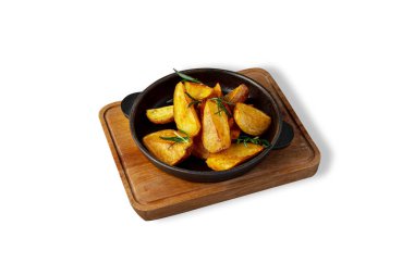 Fried potatoes with rosemary in a plate on a wooden board on a white background