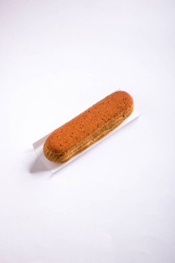 Eclair with caramel on a white background