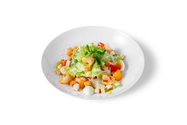 Salad with shrimps, cheese, tomatoes, croutons, lettuce, mung bean salad and eggs in a plate on a white background