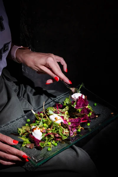 Man Holds Glass Plate His Lap Eats Fork Salad Mozzarella — Fotografia de Stock