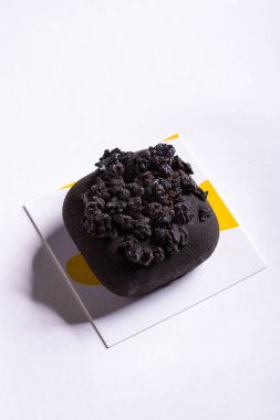 Chocolate dessert with chocolate chips on a white background