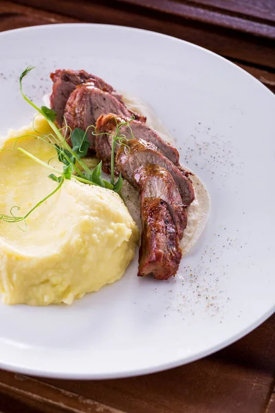 Pork Meat Mashed Potatoes Shoots White Plate Vertical Orientation — Stock Photo, Image